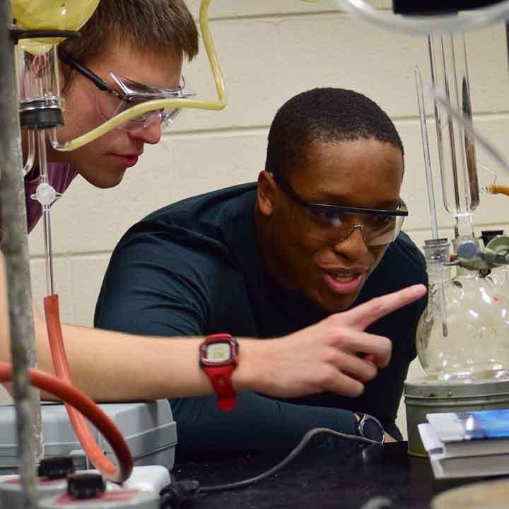 Two students working in a chemistry lab